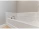 Bright white bathtub with subway tile surround at 5270 Wildwood Way, Davenport, FL 33837