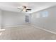 Spacious bedroom featuring carpet flooring, neutral walls, ceiling fan, and multiple windows for natural light at 5270 Wildwood Way, Davenport, FL 33837