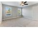 Bedroom features two windows and carpeted flooring at 5270 Wildwood Way, Davenport, FL 33837