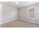 Neutral bedroom features carpet floors and a window bringing in natural light at 5270 Wildwood Way, Davenport, FL 33837