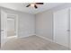 Neutral bedroom with plush carpeting and an open doorway at 5270 Wildwood Way, Davenport, FL 33837