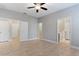 Neutral bedroom featuring tile flooring, neutral walls, and views into the bathrooms and hallways at 5270 Wildwood Way, Davenport, FL 33837