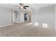 Spacious bedroom with neutral carpet, ceiling fan, and easy access to other rooms at 5270 Wildwood Way, Davenport, FL 33837