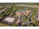 Aerial view of the community pool, sand volleyball court, and surrounding homes in a beautiful neighborhood at 5270 Wildwood Way, Davenport, FL 33837