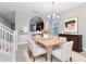 Bright dining room featuring neutral walls, large windows, and modern furnishings at 5270 Wildwood Way, Davenport, FL 33837