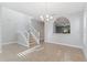 Sunlit dining room with tile floors, staircase, and sightlines to the kitchen at 5270 Wildwood Way, Davenport, FL 33837