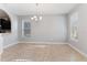 Open dining room features tile floors, a modern chandelier, and sightlines to the kitchen at 5270 Wildwood Way, Davenport, FL 33837