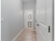 Hallway featuring tile flooring and access to the half bath at 5270 Wildwood Way, Davenport, FL 33837