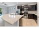 Modern kitchen featuring dark cabinets, stainless steel appliances, granite countertops, and an island at 5270 Wildwood Way, Davenport, FL 33837