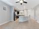 Open kitchen featuring stainless steel appliances and a large island with granite countertops at 5270 Wildwood Way, Davenport, FL 33837