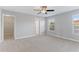 Spacious carpeted main bedroom featuring a fan and closet at 5270 Wildwood Way, Davenport, FL 33837