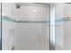 New walk-in shower features sleek glass door and decorative tile accents at 5270 Wildwood Way, Davenport, FL 33837