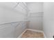 Walk-in closet featuring wire shelving and tile flooring; ideal for organization at 5270 Wildwood Way, Davenport, FL 33837