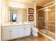 Well-lit bathroom featuring a double sink vanity and a glass-enclosed shower at 550 Las Fuentes Dr, Kissimmee, FL 34746