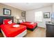 Cozy bedroom with two twin beds, Mickey Mouse themed linens, and a wall-mounted television at 550 Las Fuentes Dr, Kissimmee, FL 34746