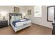 Cozy bedroom with modern furniture, wood-look flooring, and natural light at 550 Las Fuentes Dr, Kissimmee, FL 34746