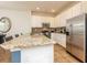 Bright kitchen with granite countertops, stainless steel appliances, and white cabinets at 550 Las Fuentes Dr, Kissimmee, FL 34746