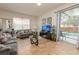 Open-concept living area with natural lighting, neutral furniture, and a view of the screened-in pool at 550 Las Fuentes Dr, Kissimmee, FL 34746
