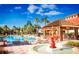 Resort-style pool area featuring lush landscaping, comfortable lounge chairs, and a decorative fountain at 550 Las Fuentes Dr, Kissimmee, FL 34746