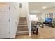 View of the carpeted stairway leading to the upper level with natural light at 550 Las Fuentes Dr, Kissimmee, FL 34746