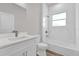 Bathroom features a white vanity, toilet and shower/tub combination with decorative tile at 5835 Sw 154 Lane Rd, Ocala, FL 34473
