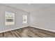 Bedroom featuring light-colored walls, wood-look flooring, and sun-filled windows at 5835 Sw 154 Lane Rd, Ocala, FL 34473