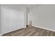 Bedroom with wood-look floors and a closet with folding doors at 5835 Sw 154 Lane Rd, Ocala, FL 34473