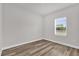 Bedroom with a bright window and wood look flooring at 5835 Sw 154 Lane Rd, Ocala, FL 34473