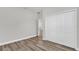 Bedroom with a spacious closet and wood-look flooring at 5835 Sw 154 Lane Rd, Ocala, FL 34473