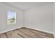 Image of a bedroom with wood look flooring and a bright window at 5835 Sw 154 Lane Rd, Ocala, FL 34473