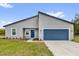 Beautiful single-story home featuring a blue garage door and well-manicured lawn at 5835 Sw 154 Lane Rd, Ocala, FL 34473