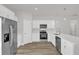 Bright kitchen features stainless steel appliances, white cabinetry, quartz countertops and wood-look flooring at 5835 Sw 154 Lane Rd, Ocala, FL 34473