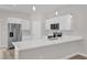 Stylish kitchen with stainless steel refrigerator, white cabinets, and quartz countertops at 5835 Sw 154 Lane Rd, Ocala, FL 34473