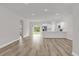 Bright, open-concept living space with modern floors flowing into a stylish kitchen at 5835 Sw 154 Lane Rd, Ocala, FL 34473