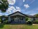 Home's backyard with a covered patio, outdoor furniture, and lush landscaping at 603 Sanctuary Golf Pl, Apopka, FL 32712