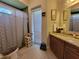 This bathroom has a door to the outside, a standing cabinet and a walk-in shower at 603 Sanctuary Golf Pl, Apopka, FL 32712