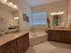 Elegant bathroom with double vanity, large tub, and updated fixtures at 603 Sanctuary Golf Pl, Apopka, FL 32712