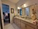This is a full bathroom with double sinks, a granite countertop, and decorative vases at 603 Sanctuary Golf Pl, Apopka, FL 32712