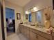 The bathroom vanity is brightly lit and decorated with personal care items at 603 Sanctuary Golf Pl, Apopka, FL 32712