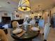 The dining area showcases a round table set for four, with a view of the open floor plan and modern kitchen at 603 Sanctuary Golf Pl, Apopka, FL 32712