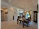 An elegant dining room with hardwood floors, crown molding, and a charming chandelier above the dark wood table at 603 Sanctuary Golf Pl, Apopka, FL 32712