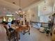 The dining area features a dark wood table and chandelier with views into the living room at 603 Sanctuary Golf Pl, Apopka, FL 32712