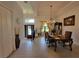Open-concept foyer with hardwood floors, dining area, and lots of natural light at 603 Sanctuary Golf Pl, Apopka, FL 32712