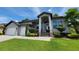 Inviting front exterior featuring a well-maintained lawn, elegant landscaping, and a welcoming entrance at 603 Sanctuary Golf Pl, Apopka, FL 32712