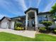 Inviting front exterior featuring a well-maintained lawn, elegant landscaping, and a welcoming entrance at 603 Sanctuary Golf Pl, Apopka, FL 32712