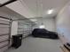 Spacious two-car garage with a black SUV, an automatic door opener, and ample storage space at 603 Sanctuary Golf Pl, Apopka, FL 32712