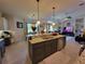 Open kitchen with a large island, stainless steel appliances, and open floor plan at 603 Sanctuary Golf Pl, Apopka, FL 32712