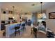 A modern kitchen with a center island, barstool seating, and stainless steel appliances, perfect for entertaining at 603 Sanctuary Golf Pl, Apopka, FL 32712