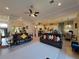 Spacious living room area with tile floors, large windows, and modern ceiling fan at 603 Sanctuary Golf Pl, Apopka, FL 32712