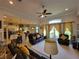 The open-concept living room features a comfortable leather sofa and chairs, and a view of the kitchen at 603 Sanctuary Golf Pl, Apopka, FL 32712